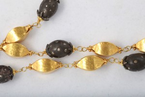 A close up of the necklace on a white surface