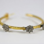 A close up of the bracelet with three flowers