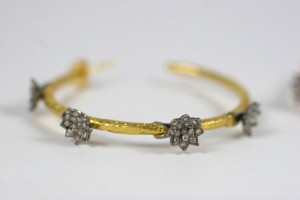 A close up of the bracelet with three flowers