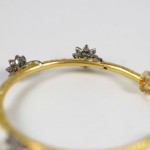 A close up of the bottom of a gold bracelet