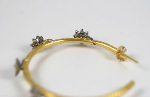 A close up of the bottom of a gold bracelet