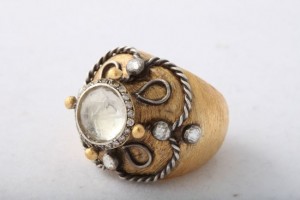 A gold ring with some white stones on it