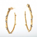 A pair of gold and diamond hoop earrings.