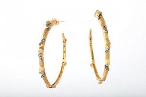A pair of gold and diamond hoop earrings.