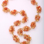 A long necklace of orange and gold beads.