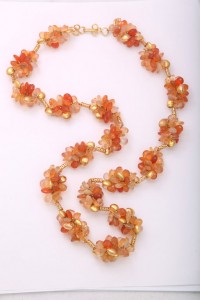 A long necklace of orange and gold beads.