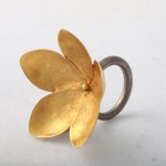 A gold flower ring with a silver band.