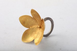 A gold flower ring with a silver band.