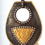 A gold and diamond decorated purse with a metal frame.