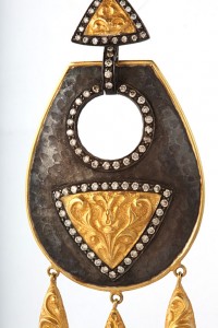 A gold and diamond decorated purse with a metal frame.