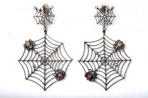 A pair of spider web earrings with pink stones.