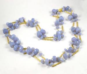 A long necklace of blue beads and yellow accents.