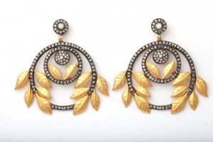 A pair of earrings with gold and diamond leaves.