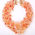 A necklace of orange beads is shown.