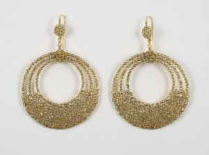 A pair of gold earrings with a circular design.