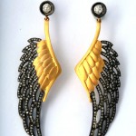 A pair of earrings with wings and diamonds.