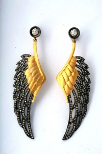 A pair of earrings with wings and diamonds.