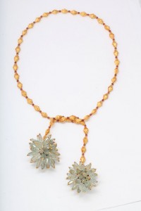 A necklace with two flowers and beads.