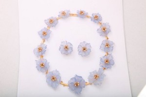 A necklace and earrings set made of plastic flowers.