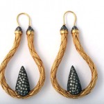 A pair of earrings with gold and silver wire.