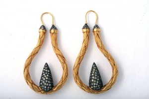 A pair of earrings with gold and silver wire.