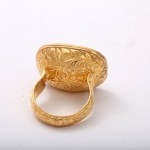 A gold ring with a leaf design on it.