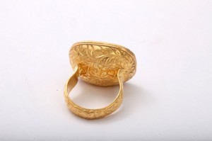 A gold ring with a leaf design on it.