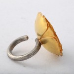 A ring with a gold leaf on it.