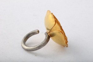A ring with a gold leaf on it.