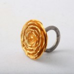 A gold flower ring with a silver band.