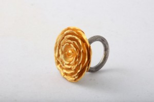 A gold flower ring with a silver band.