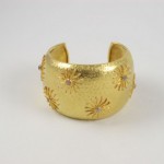 A gold cuff with a star design on it.