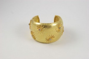 A gold cuff with a star design on it.