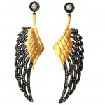 A pair of earrings with wings and black diamonds.