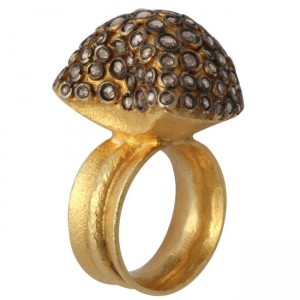 A gold ring with a dome shaped diamond encrusted top.
