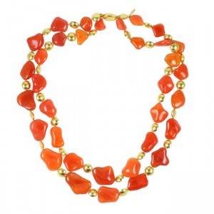 A long necklace of orange and gold beads