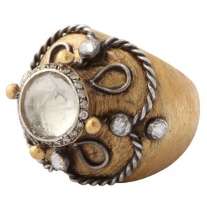 A wooden ring with metal and glass stones.