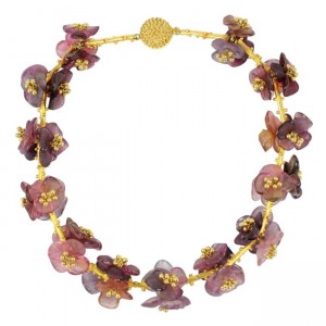 A necklace of purple flowers with gold beads.
