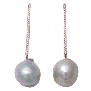 A pair of long silver earrings with pearls and diamonds.