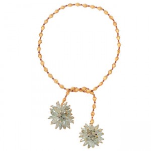 A gold chain with two flowers on it.