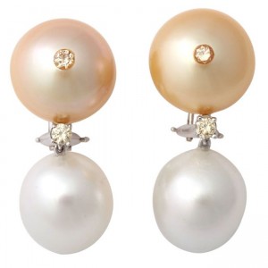 A pair of earrings with pearls and diamonds.