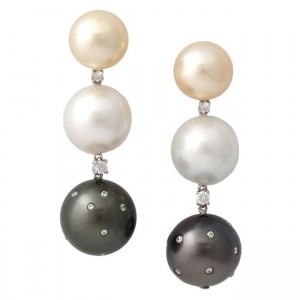 A pair of earrings with pearls and diamonds.