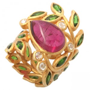 A gold ring with green leaves and a pink stone.