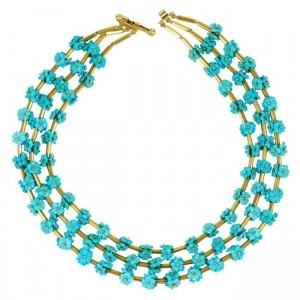 A necklace with three strands of turquoise beads.