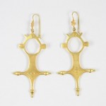 A pair of gold earrings with a cross design.