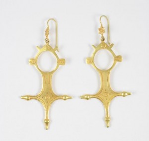 A pair of gold earrings with a cross design.
