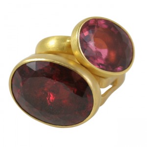 A gold ring with two large red stones.