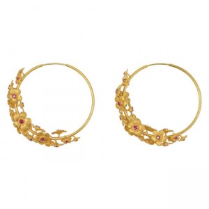 A pair of gold hoop earrings with red stones.