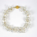 A necklace of clear glass beads and gold clasp.