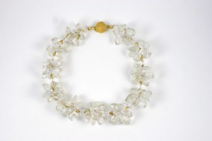 A necklace of clear glass beads and gold clasp.